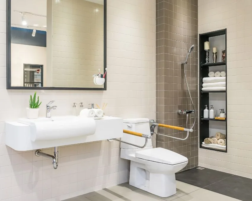 Accessible bathroom remodeled for aging in place with grab bars, a roll-under sink and a walk-in shower